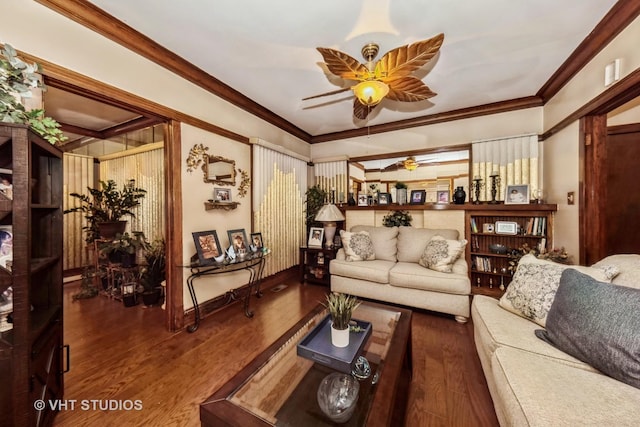 living room featuring baseboards, a ceiling fan, wood finished floors, and crown molding