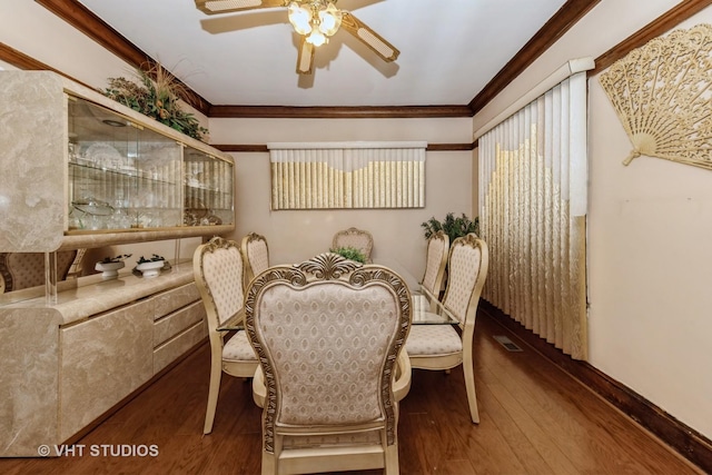 dining area featuring baseboards, visible vents, ceiling fan, crown molding, and hardwood / wood-style floors