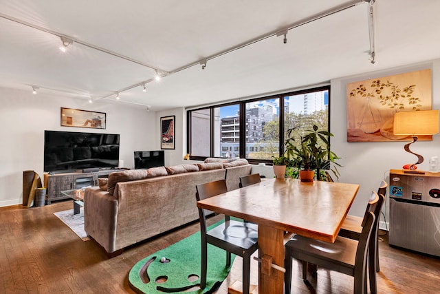 living room with rail lighting, baseboards, and wood-type flooring