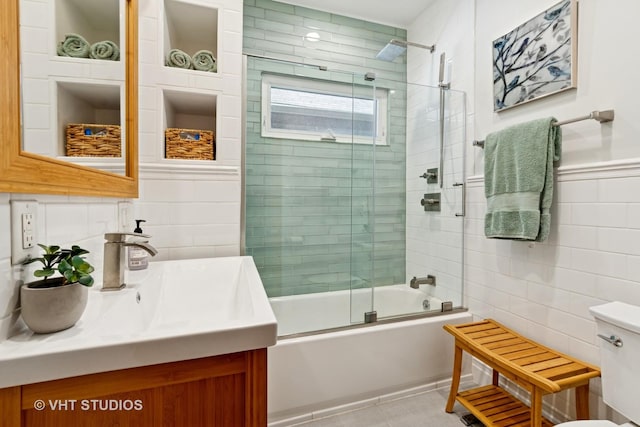 1515 W Glenlake Ave, Chicago, IL 60660 - bathroom featuring tile walls, vanity, and shower / bath combination with glass door