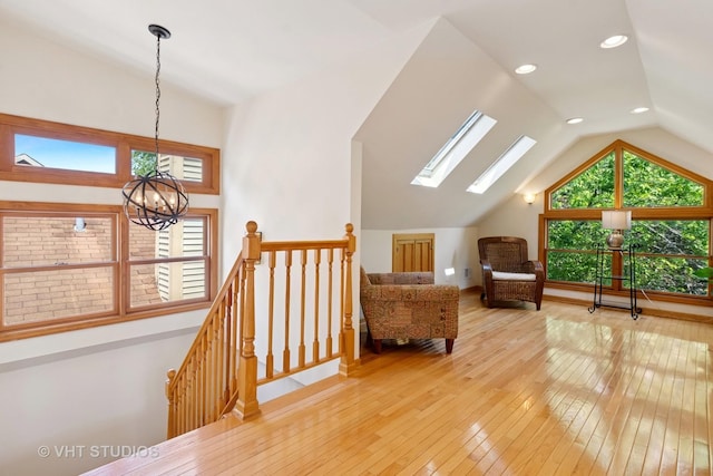1515 W Glenlake Ave, Chicago, IL 60660 - living area with lofted ceiling, an upstairs landing, hardwood / wood-style floors, a chandelier, and a skylight