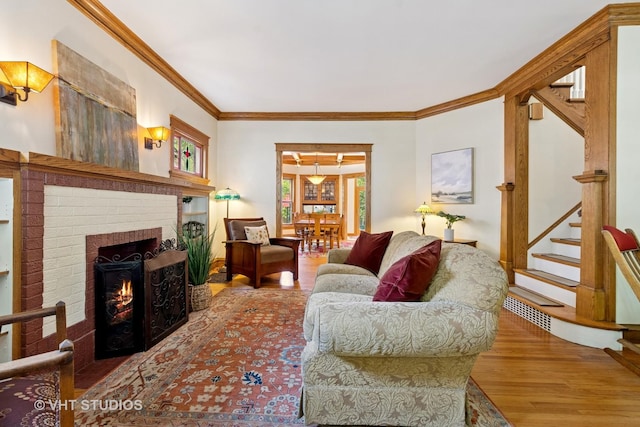 1515 W Glenlake Ave, Chicago, IL 60660 - living room with stairs, a brick fireplace, ornamental molding, and wood finished floors