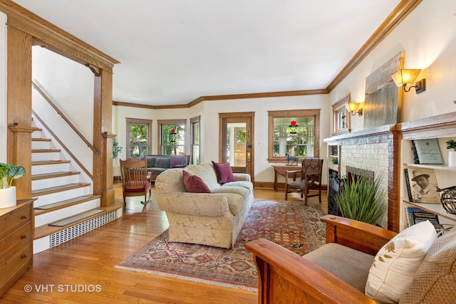 1515 W Glenlake Ave, Chicago, IL 60660 - living room with healthy amount of natural light, wood finished floors, a brick fireplace, stairs, and crown molding