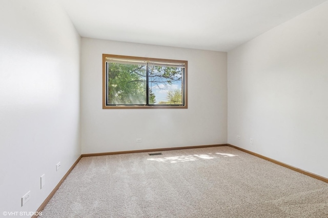 carpeted empty room with baseboards