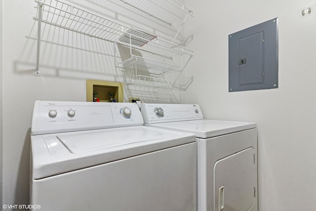 clothes washing area with electric panel and washer and dryer