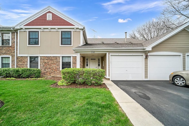 218 Oak Knoll Ct Unit D1, Schaumburg, IL 60193 - view of front of property featuring driveway, an attached garage, a front yard, and brick siding