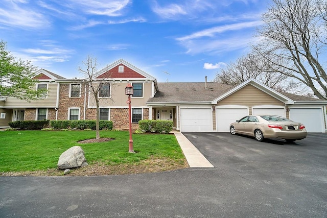 218 Oak Knoll Ct Unit D1, Schaumburg, IL 60193 - view of front of house with an attached garage, asphalt driveway, a front lawn, and brick siding