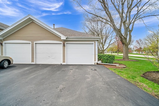 218 Oak Knoll Ct Unit D1, Schaumburg, IL 60193 - view of front of property with a garage, a shingled roof, a front yard, and an outbuilding