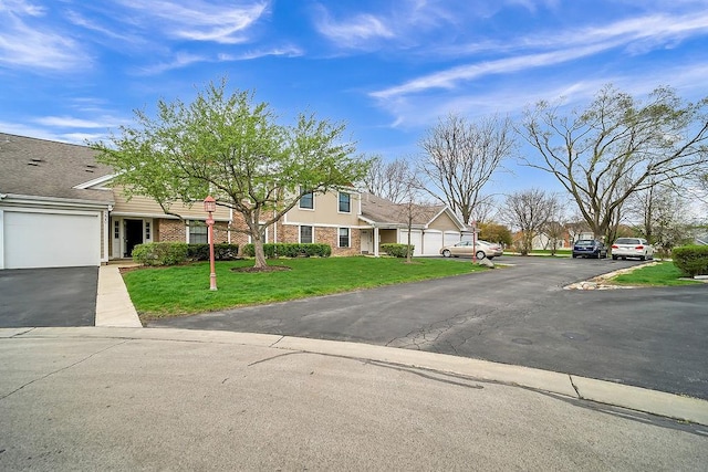 218 Oak Knoll Ct Unit D1, Schaumburg, IL 60193 - view of front facade featuring a front lawn, brick siding, and a residential view