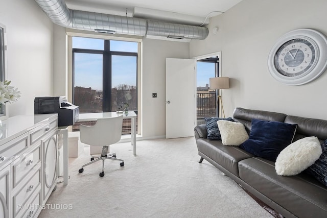 office with a healthy amount of sunlight and light colored carpet