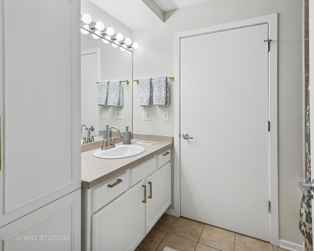 bathroom with tile patterned flooring and vanity