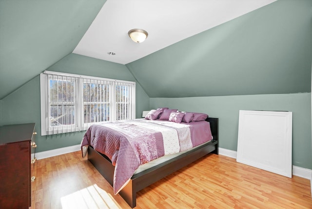 3024 E Ave, Berwyn, IL 60402 - bedroom featuring lofted ceiling, wood finished floors, and baseboards