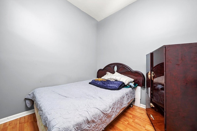 3024 E Ave, Berwyn, IL 60402 - bedroom featuring vaulted ceiling, baseboards, and wood finished floors