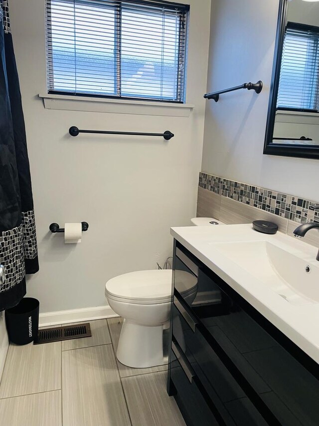 bathroom featuring toilet, tile patterned floors, visible vents, and vanity