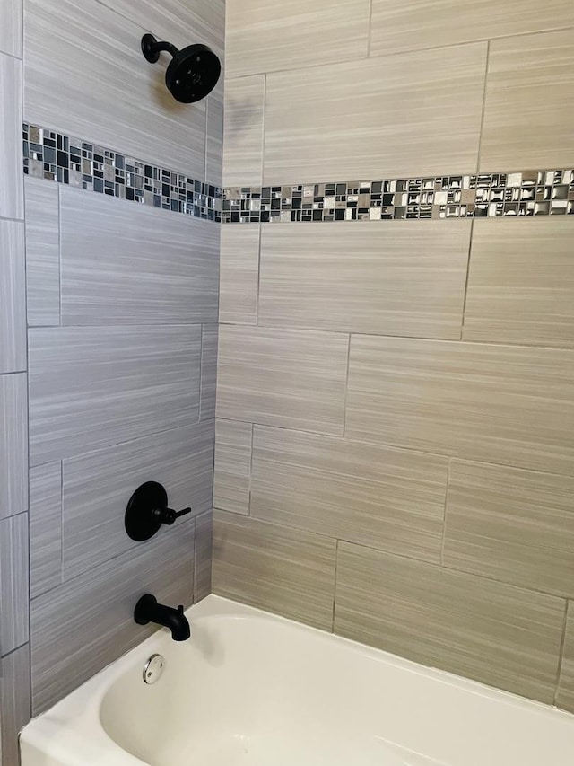 bathroom with bathing tub / shower combination