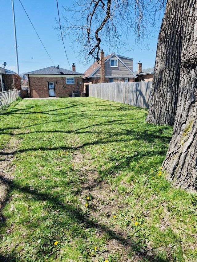 view of yard with fence and cooling unit