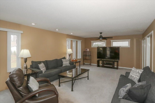 living room featuring ceiling fan, baseboards, recessed lighting, and light carpet