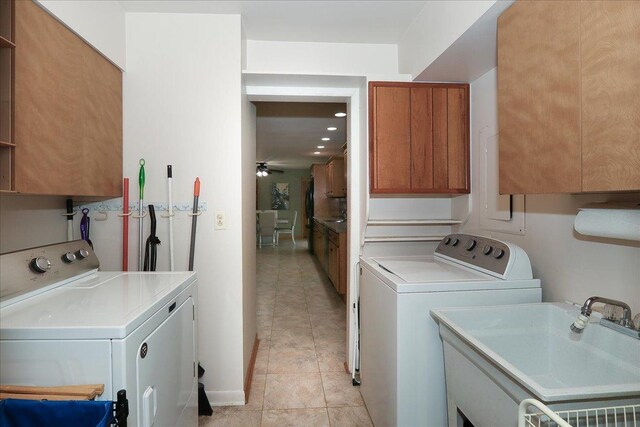 washroom featuring washer and dryer, cabinet space, ceiling fan, a sink, and light tile patterned flooring