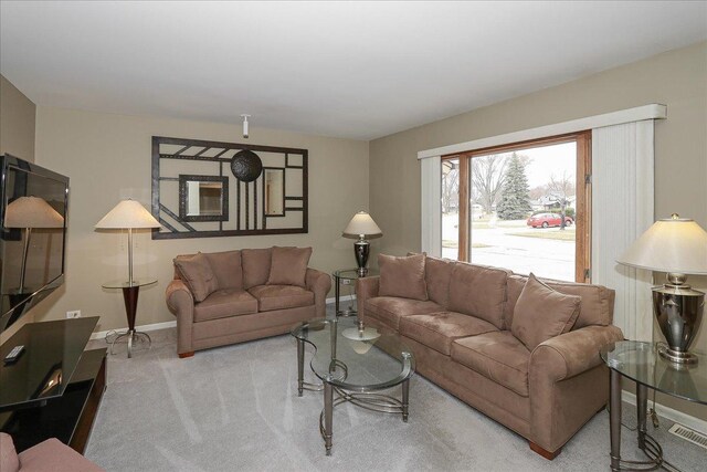 living room featuring carpet flooring and baseboards