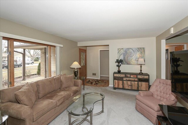 carpeted living area with baseboards