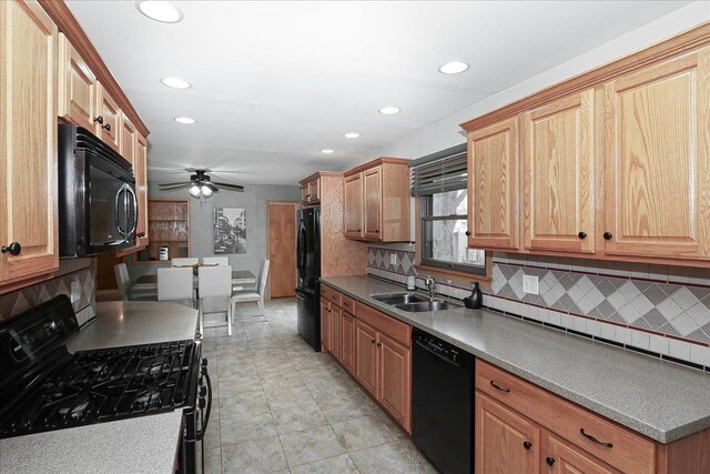 kitchen with recessed lighting, black appliances, backsplash, and a sink