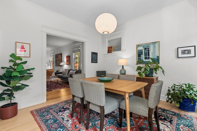 1942 Orrington Ave, Evanston, IL 60201 - dining area with baseboards, wood finished floors, and crown molding