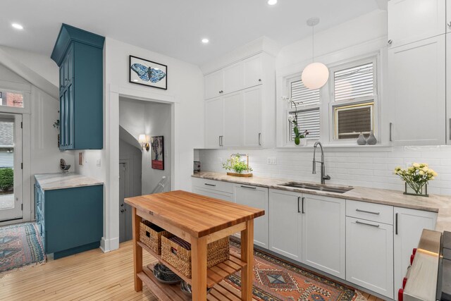 1942 Orrington Ave, Evanston, IL 60201 - kitchen featuring recessed lighting, a sink, decorative backsplash, light wood-type flooring, and white cabinetry