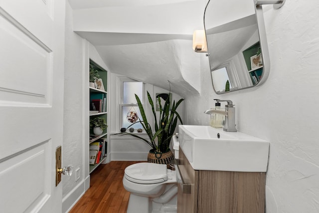 1942 Orrington Ave, Evanston, IL 60201 - half bathroom featuring toilet, vanity, a textured wall, and wood finished floors
