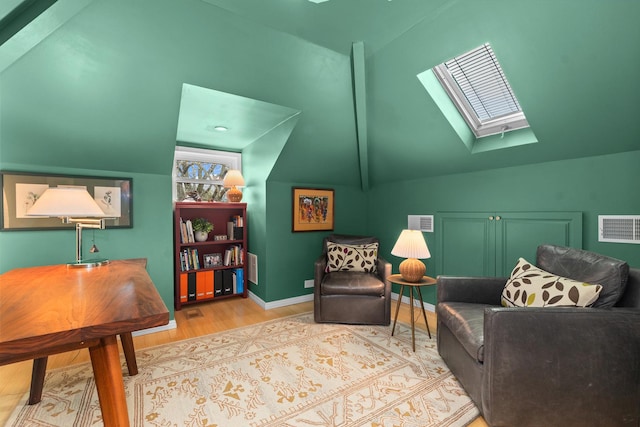 1942 Orrington Ave, Evanston, IL 60201 - living area featuring baseboards, visible vents, wood finished floors, and lofted ceiling with skylight