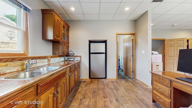 2220 Manico Dr, Crest Hill, IL 60403 - kitchen featuring freestanding refrigerator, a drop ceiling, brown cabinetry, light wood-type flooring, and backsplash