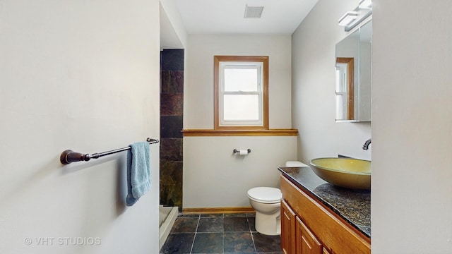 2220 Manico Dr, Crest Hill, IL 60403 - bathroom featuring vanity, walk in shower, and stone finish floors