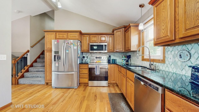 2220 Manico Dr, Crest Hill, IL 60403 - kitchen with appliances with stainless steel finishes, light wood finished floors, brown cabinets, lofted ceiling, and decorative light fixtures