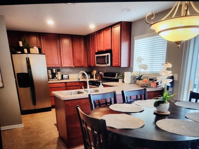 24622 George Washington Dr, Plainfield, IL 60544 - kitchen featuring appliances with stainless steel finishes, a peninsula, tasteful backsplash, light countertops, and recessed lighting