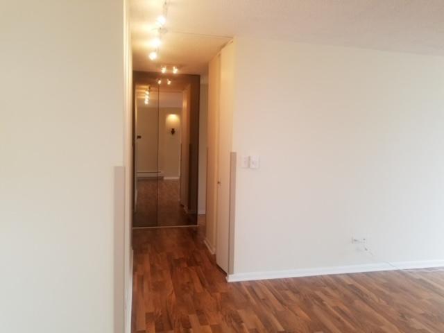 5401 S Hyde Park Blvd Unit 705, Chicago, IL 60615 - hallway featuring baseboards and wood finished floors