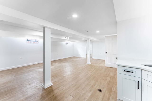 finished basement with recessed lighting, baseboards, and light wood-style flooring
