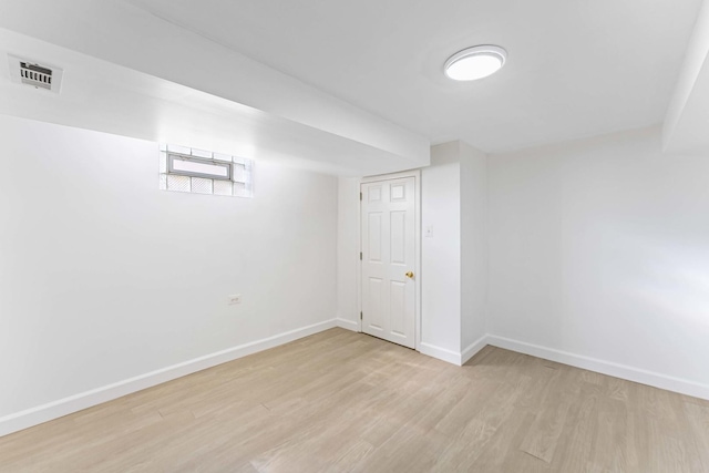 below grade area featuring light wood-type flooring and baseboards