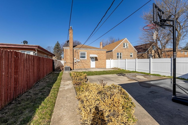 view of yard with a patio area, a fenced backyard, and central AC unit