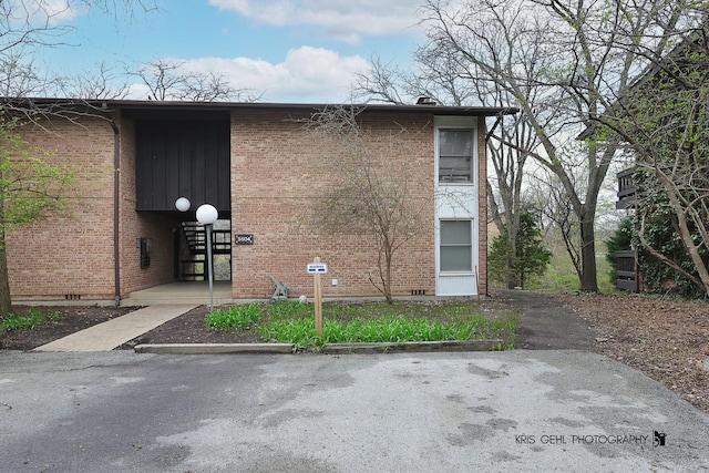 view of side of home with brick siding