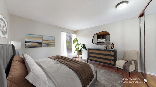 bedroom featuring wood finished floors and baseboards