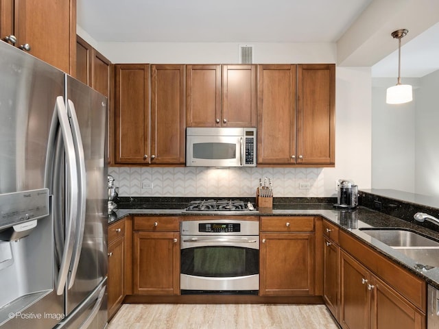600 N Lake Shore Dr Unit 1802, Chicago, IL 60611 - kitchen with a sink, dark stone countertops, appliances with stainless steel finishes, and brown cabinets