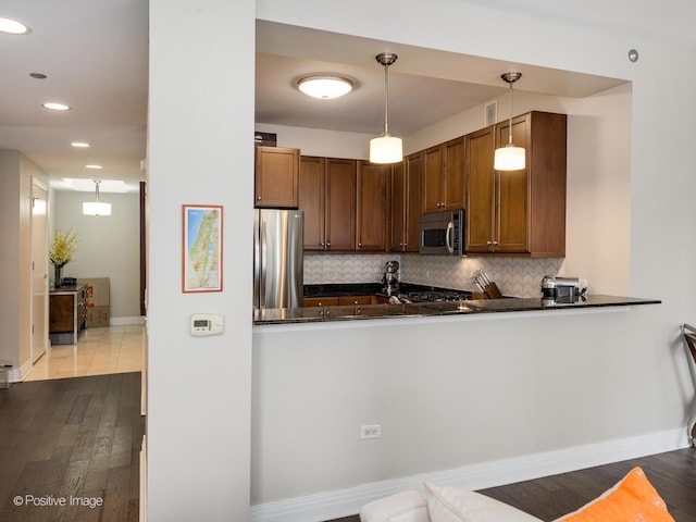 600 N Lake Shore Dr Unit 1802, Chicago, IL 60611 - kitchen with dark countertops, appliances with stainless steel finishes, tasteful backsplash, dark wood finished floors, and baseboards