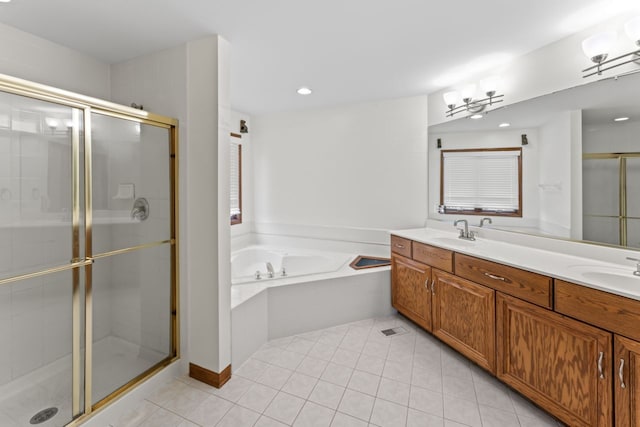 full bath featuring a bath, a shower stall, tile patterned flooring, and a sink