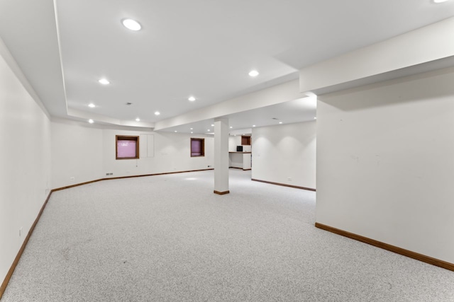 finished basement with light carpet and baseboards