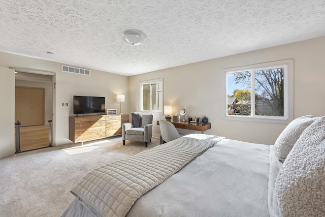 2104 Oakwood Ave, Bloomington, IL 61704 - bedroom featuring a textured ceiling, visible vents, and carpet flooring