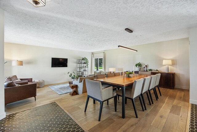 2104 Oakwood Ave, Bloomington, IL 61704 - dining area with a textured ceiling, hardwood / wood-style floors, and baseboards