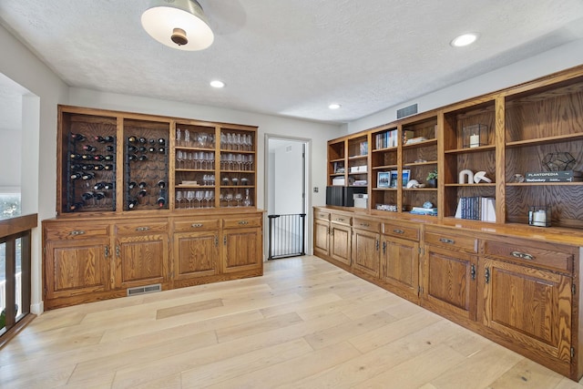 2104 Oakwood Ave, Bloomington, IL 61704 - wine room featuring light wood finished floors, a textured ceiling, visible vents, and recessed lighting