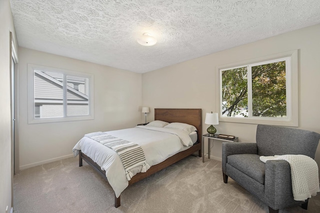 2104 Oakwood Ave, Bloomington, IL 61704 - bedroom featuring baseboards, carpet floors, and a textured ceiling