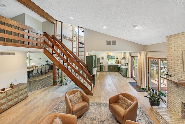 2104 Oakwood Ave, Bloomington, IL 61704 - interior space with a textured ceiling, visible vents, a wealth of natural light, and hardwood / wood-style flooring