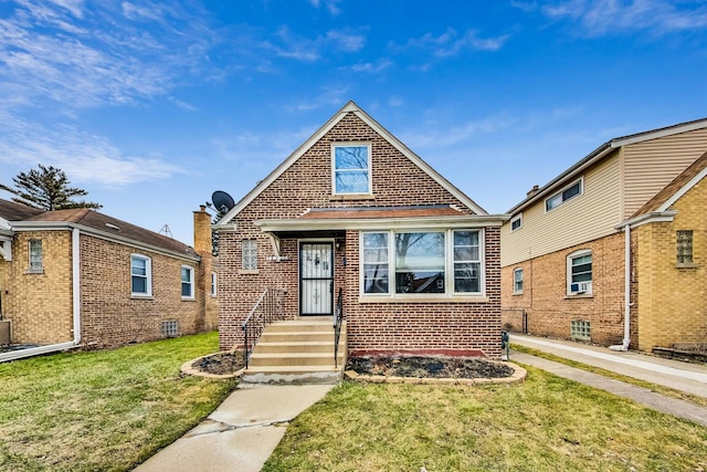 bungalow-style house featuring brick siding and a front yard