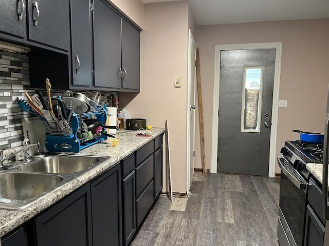 2809 Gilead Ave, Zion, IL 60099 - kitchen featuring tasteful backsplash, a sink, light countertops, black range with gas stovetop, and dark wood-style floors